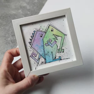 a hand holding a picture of two monsters