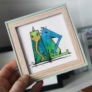 a hand holding a picture of two monsters