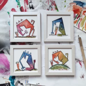 a group of framed pictures on a table