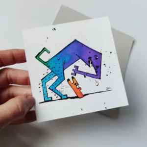 a hand holding a piece of paper with a drawing of a dog