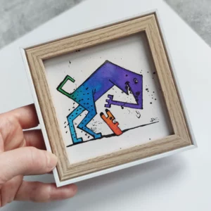 a hand holding a picture of a dog