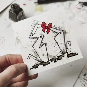 a hand holding a piece of paper with a drawing of a dog