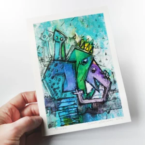 a hand holding a piece of art